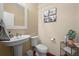 Half bathroom with pedestal sink and decorative wall art at 4887 Raven Run, Broomfield, CO 80023