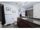 Bathroom with dark vanity and shower with tiled walls at 4887 Raven Run, Broomfield, CO 80023