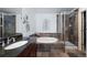 Beautiful bathroom featuring double sinks, granite counters, a soaking tub, and glass shower at 4887 Raven Run, Broomfield, CO 80023