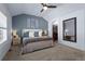 Well lit and airy main bedroom offering a cozy king bed, cool accent wall, and an ensuite bathroom entrance at 4887 Raven Run, Broomfield, CO 80023