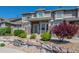 Beautiful townhome with a stone exterior, landscaping, and a well-maintained front yard at 4887 Raven Run, Broomfield, CO 80023