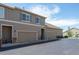 Townhome exterior with garage, neutral siding, and stone accents provides ample parking and curb appeal at 4887 Raven Run, Broomfield, CO 80023