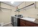 Laundry room equipped with washer, dryer, sink and shelving at 4887 Raven Run, Broomfield, CO 80023