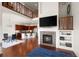 Open-concept living space with fireplace, hardwood floors, and modern decor at 4887 Raven Run, Broomfield, CO 80023