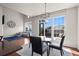Bright dining area with a modern chandelier and large windows at 4887 Raven Run, Broomfield, CO 80023