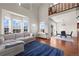 Bright and airy living room with hardwood floors, comfortable seating, and dining area at 4887 Raven Run, Broomfield, CO 80023