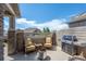 Cozy patio space featuring comfortable seating, outdoor grill, and privacy fencing at 4887 Raven Run, Broomfield, CO 80023