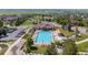 Overhead view of the community pool, featuring clear blue water, lounge chairs, and parking area at 4887 Raven Run, Broomfield, CO 80023