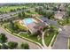 Aerial view of a community pool, showcasing the pool, clubhouse, and surrounding green spaces at 4887 Raven Run, Broomfield, CO 80023