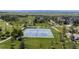 Aerial view of community tennis courts surrounded by lush green lawns and mature trees at 4887 Raven Run, Broomfield, CO 80023