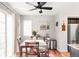 Bright dining room with hardwood floors, a table for four, and a ceiling fan at 1503 S Buckley Way, Aurora, CO 80017