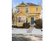 Two-story yellow house with blue door, snowy front yard, charming details at 1503 S Buckley Way, Aurora, CO 80017
