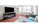 Living room featuring hardwood floors, fireplace, and ample natural light at 1503 S Buckley Way, Aurora, CO 80017