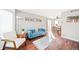 Bright living room with hardwood floors, comfy seating, and access to dining area at 1503 S Buckley Way, Aurora, CO 80017