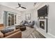 Bright living room with fireplace, hardwood floors, and sliding glass door to patio at 8757 E Dry Creek Rd # 1512, Englewood, CO 80112