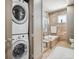 Washer/dryer with soaking tub, tiled walls, modern vanity, and sleek fixtures for a spa-like experience at 5455 Landmark Pl # 1414, Greenwood Village, CO 80111