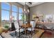 Elegant dining room features a round table with seating and scenic city views through expansive windows at 5455 Landmark Pl # 1414, Greenwood Village, CO 80111