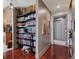 Hallway featuring hardwood floors, a built-in bookshelf, and neutral paint at 5455 Landmark Pl # 1414, Greenwood Village, CO 80111