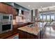 Beautiful kitchen featuring cherry cabinets, stainless appliances, granite counters, and an open layout to the living area at 5455 Landmark Pl # 1414, Greenwood Village, CO 80111