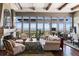 Bright living room featuring large windows, hardwood floors, and cozy seating at 5455 Landmark Pl # 1414, Greenwood Village, CO 80111