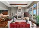 Spacious living room with a fireplace, comfortable seating, and ample natural light from large windows at 5455 Landmark Pl # 1414, Greenwood Village, CO 80111