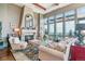 Inviting living room featuring large windows with views, comfortable seating, and a striking fireplace at 5455 Landmark Pl # 1414, Greenwood Village, CO 80111