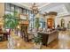 Elegant living room featuring a stone fireplace, large windows, and a grand chandelier at 5455 Landmark Pl # 1414, Greenwood Village, CO 80111