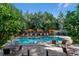 Community pool featuring lush landscaping, lounge chairs, and umbrellas, creating a resort-style experience at 5455 Landmark Pl # 1414, Greenwood Village, CO 80111