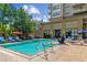 Beautiful community pool with comfortable lounge chairs and umbrellas, inviting relaxation and socializing at 5455 Landmark Pl # 1414, Greenwood Village, CO 80111