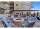 Inviting rooftop lounge area with comfortable seating surrounding a cozy fire pit, perfect for socializing at 5455 Landmark Pl # 1414, Greenwood Village, CO 80111