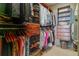 Spacious walk-in closet with custom shelving, drawers, and hanging racks for optimal organization and storage at 5455 Landmark Pl # 1414, Greenwood Village, CO 80111