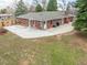 Expansive backyard featuring a brick home, spacious patio, mature trees, and a well-maintained lawn at 1723 Stonehenge Dr, Lafayette, CO 80026