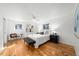 Bright bedroom features wood floors, large windows, and a comfortable bed with stylish decor at 1723 Stonehenge Dr, Lafayette, CO 80026