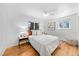 Bright bedroom with hardwood floors, a cozy bed, and natural light from dual windows at 1723 Stonehenge Dr, Lafayette, CO 80026