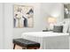 Bright bedroom featuring a comfortable bed, stylish art, and a cozy bench at 1723 Stonehenge Dr, Lafayette, CO 80026