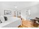 Bright bedroom features wood floors and sliding glass doors to ensuite bathroom at 1723 Stonehenge Dr, Lafayette, CO 80026