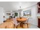Bright dining room with a round wood table, four pink upholstered chairs, and a modern chandelier at 1723 Stonehenge Dr, Lafayette, CO 80026