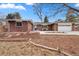 Charming brick home with a well-manicured lawn, mature trees, and an attached two-car garage at 1723 Stonehenge Dr, Lafayette, CO 80026