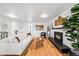 A spacious living room with hardwood floors, a fireplace, and stylish furniture at 1723 Stonehenge Dr, Lafayette, CO 80026