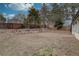 Large backyard with a rock border, mature trees, and a wood fence at 7249 S Iris Ct, Littleton, CO 80128