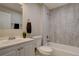 Bathroom showcasing a tub, modern sink and neutral tiling at 7249 S Iris Ct, Littleton, CO 80128