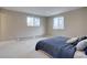 Spacious bedroom with plush carpeting and two windows offering natural light at 7249 S Iris Ct, Littleton, CO 80128