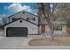 Charming two-story home featuring a brick exterior, a well-manicured lawn, and a two-car garage at 7249 S Iris Ct, Littleton, CO 80128