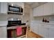 Modern kitchen featuring stainless steel appliances and white cabinetry at 7249 S Iris Ct, Littleton, CO 80128