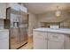 Modern kitchen featuring stainless steel appliances, white cabinetry, and hardwood floors at 7249 S Iris Ct, Littleton, CO 80128