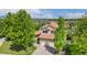 Aerial view of the home showing the two-car garage, trees, and landscaping at 11335 W 54Th Ln, Arvada, CO 80002