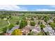 An aerial view of a neighborhood showing houses, lawns, and large green fields at 11335 W 54Th Ln, Arvada, CO 80002