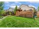 A backyard with a large lawn, a wood fence, a small vegetable garden, and a gazebo at 11335 W 54Th Ln, Arvada, CO 80002