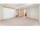 Neutral colored basement features carpet, neutral walls, and multiple doorways at 11335 W 54Th Ln, Arvada, CO 80002