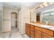 Bright bathroom featuring double sinks, granite countertops, and a walk-in closet at 11335 W 54Th Ln, Arvada, CO 80002